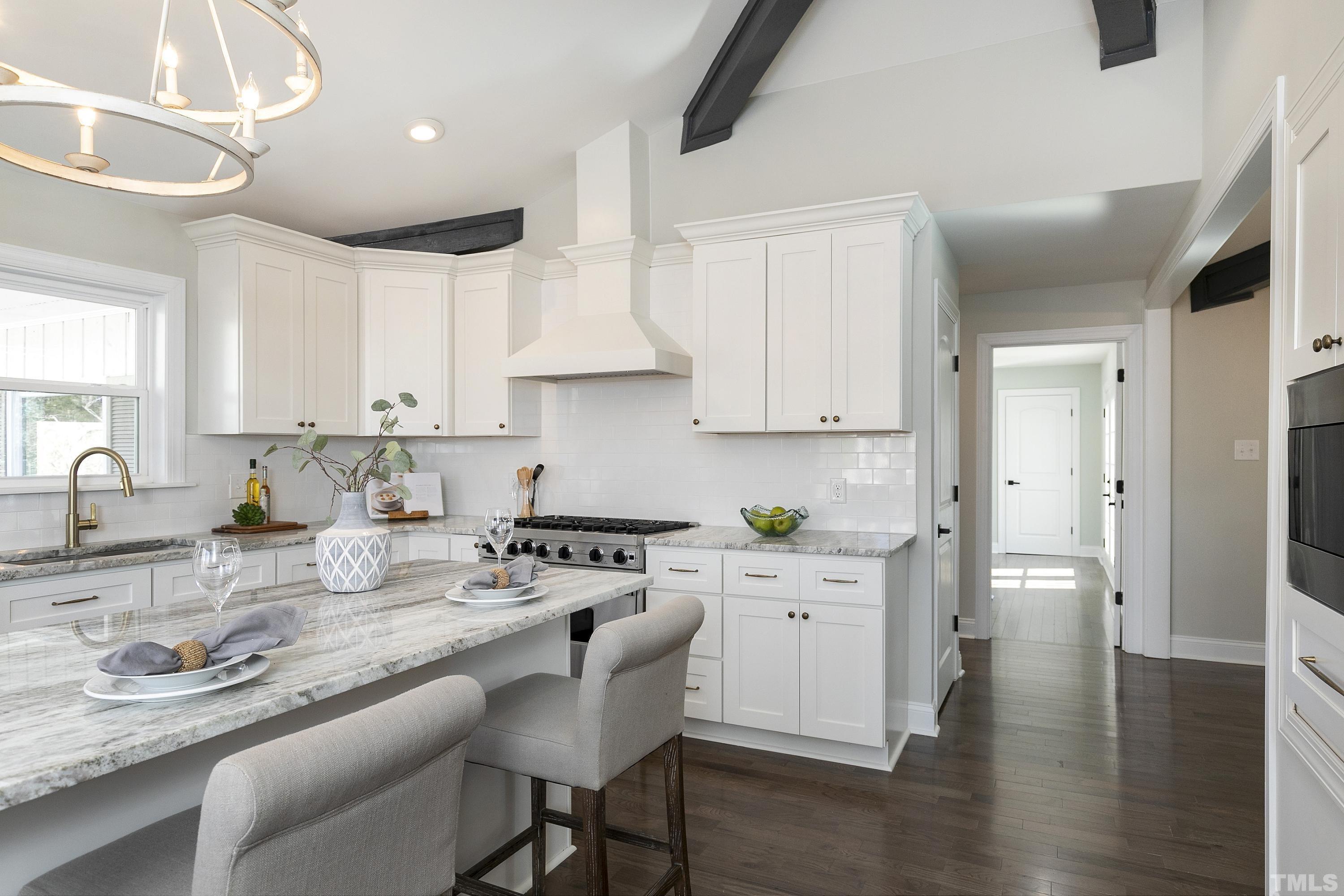 5413 Edington Lane Raleigh, NC 27604 - Photo 14 of 59 a kitchen with stainless steel appliances granite countertop a stove a sink dishwasher and cabinets with wooden floor