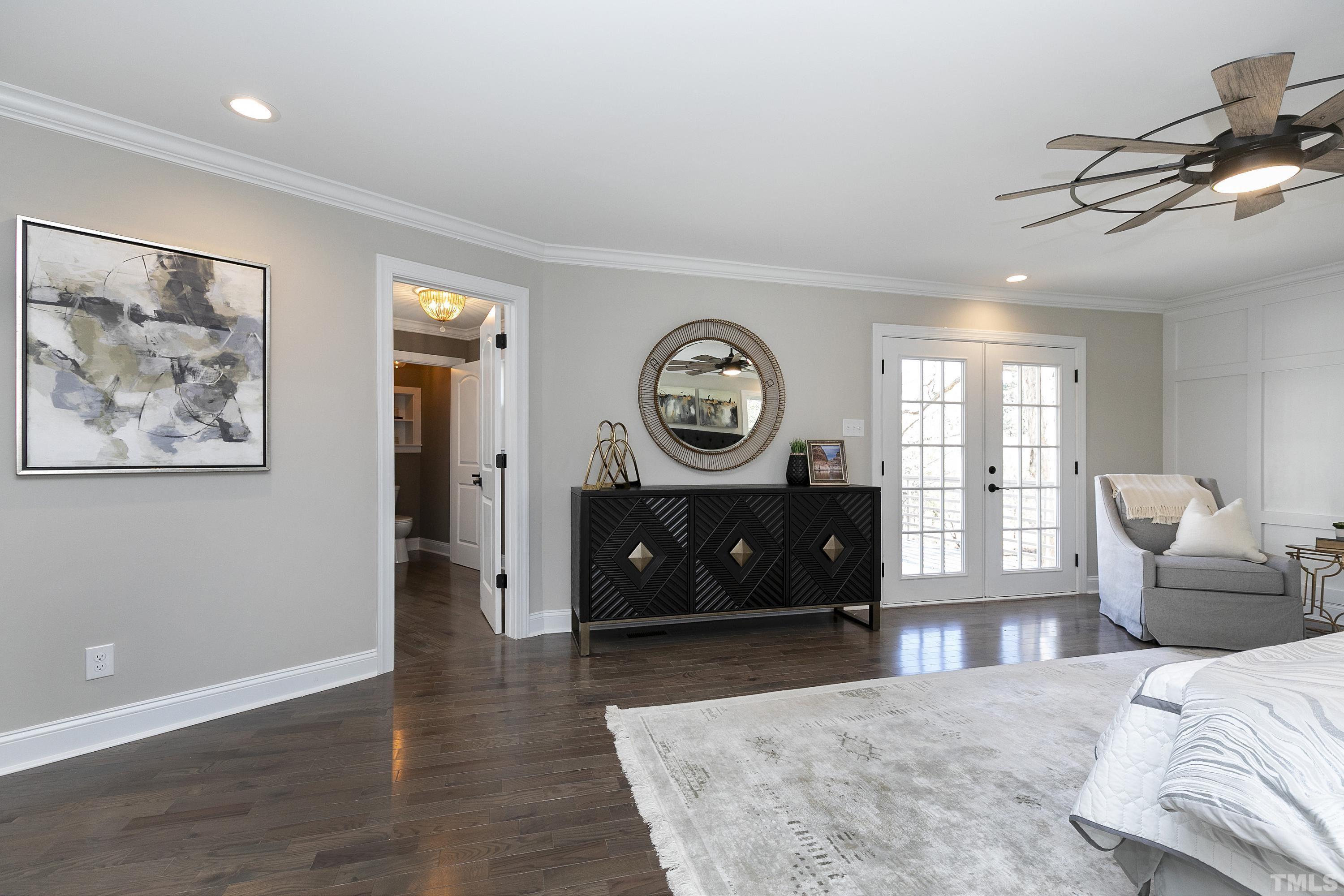 5413 Edington Lane Raleigh, NC 27604 - Photo 18 of 59 a bedroom with a bed a mirror and a window