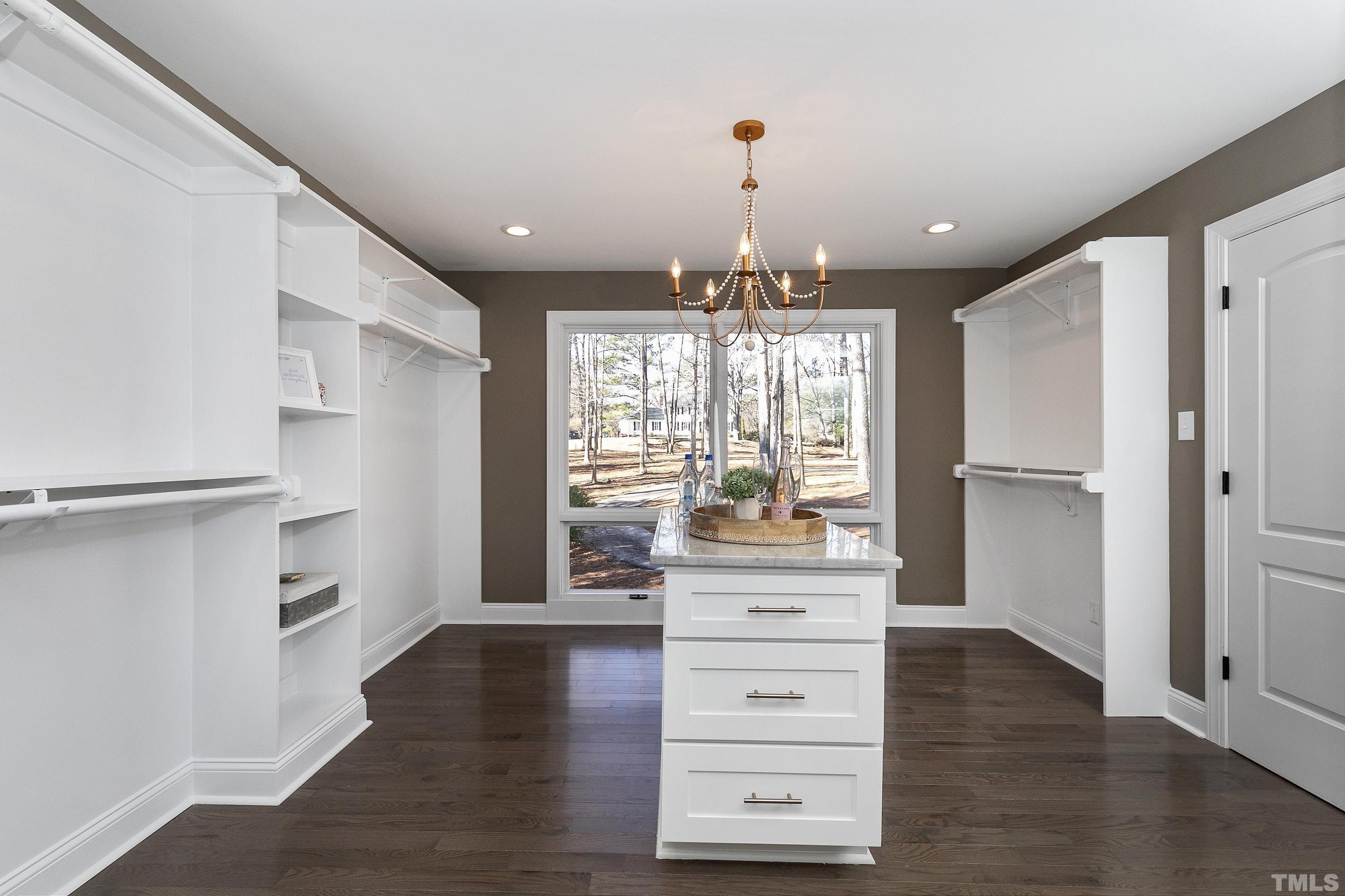 5413 Edington Lane Raleigh, NC 27604 - Photo 19 of 59 a view of a hallway with wooden floor windows and a kitchen