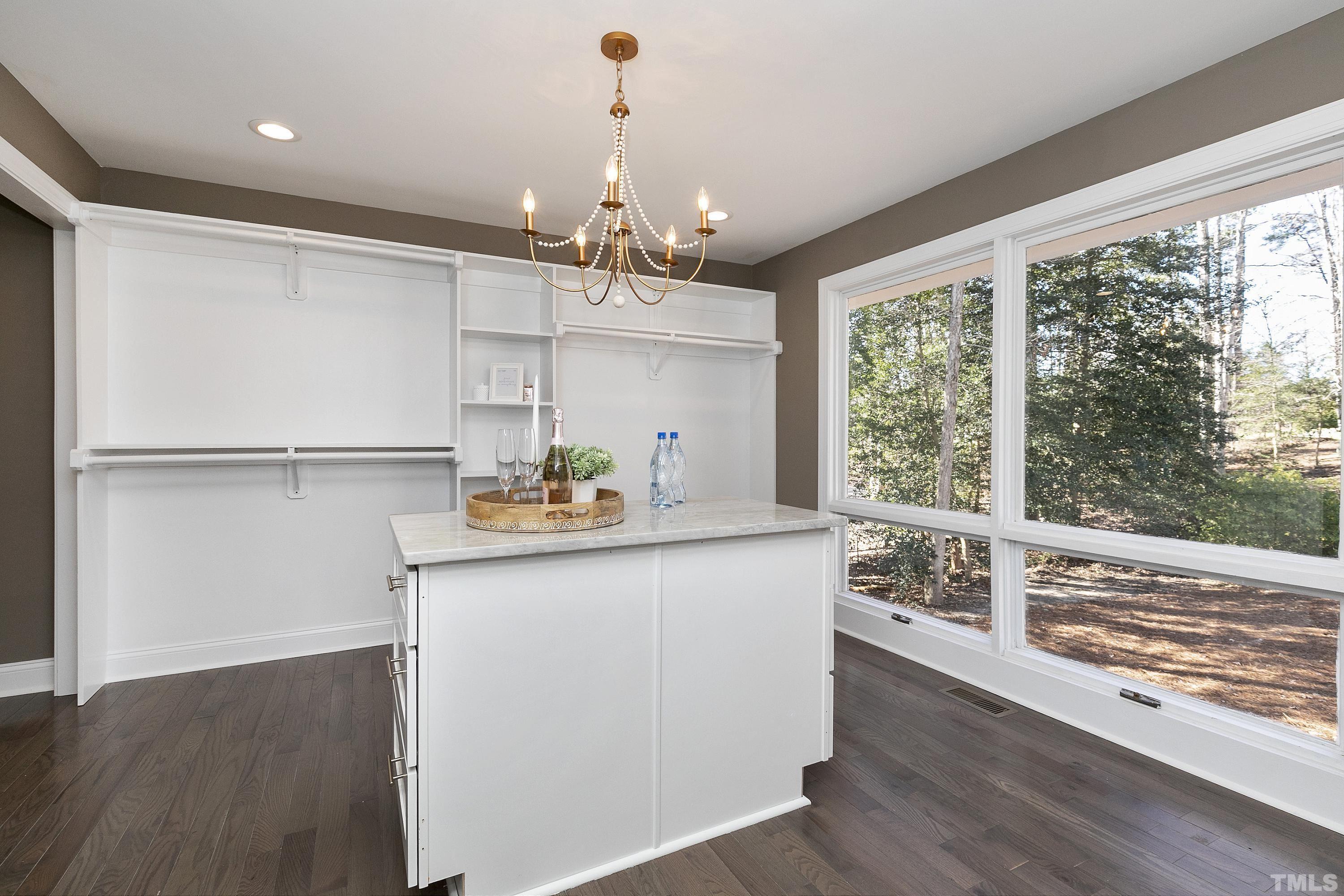 5413 Edington Lane Raleigh, NC 27604 - Photo 20 of 59 a kitchen with kitchen island a wooden floor and a window
