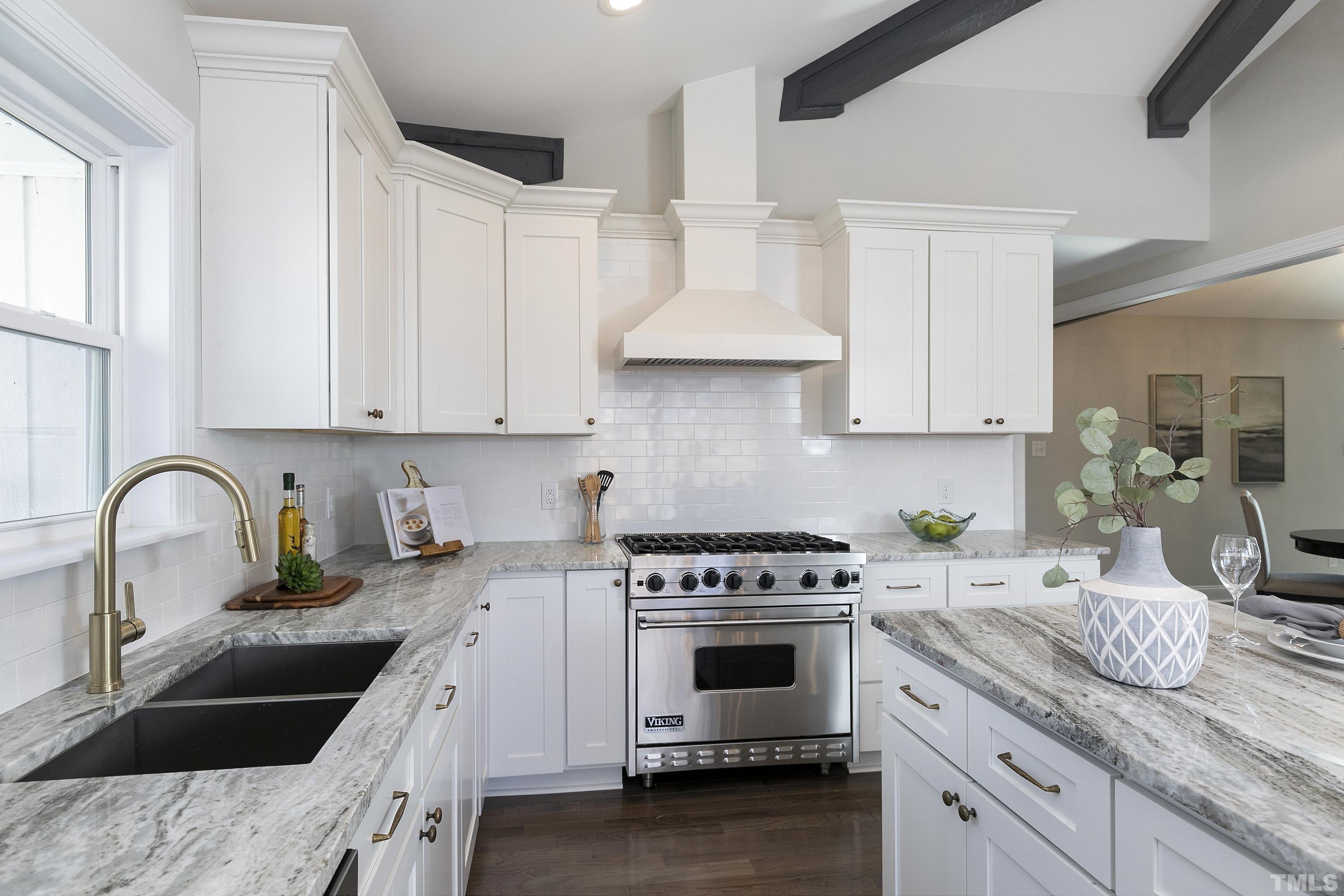 5413 Edington Lane Raleigh, NC 27604 - Photo 25 of 59 a kitchen with granite countertop a sink a stove and cabinets