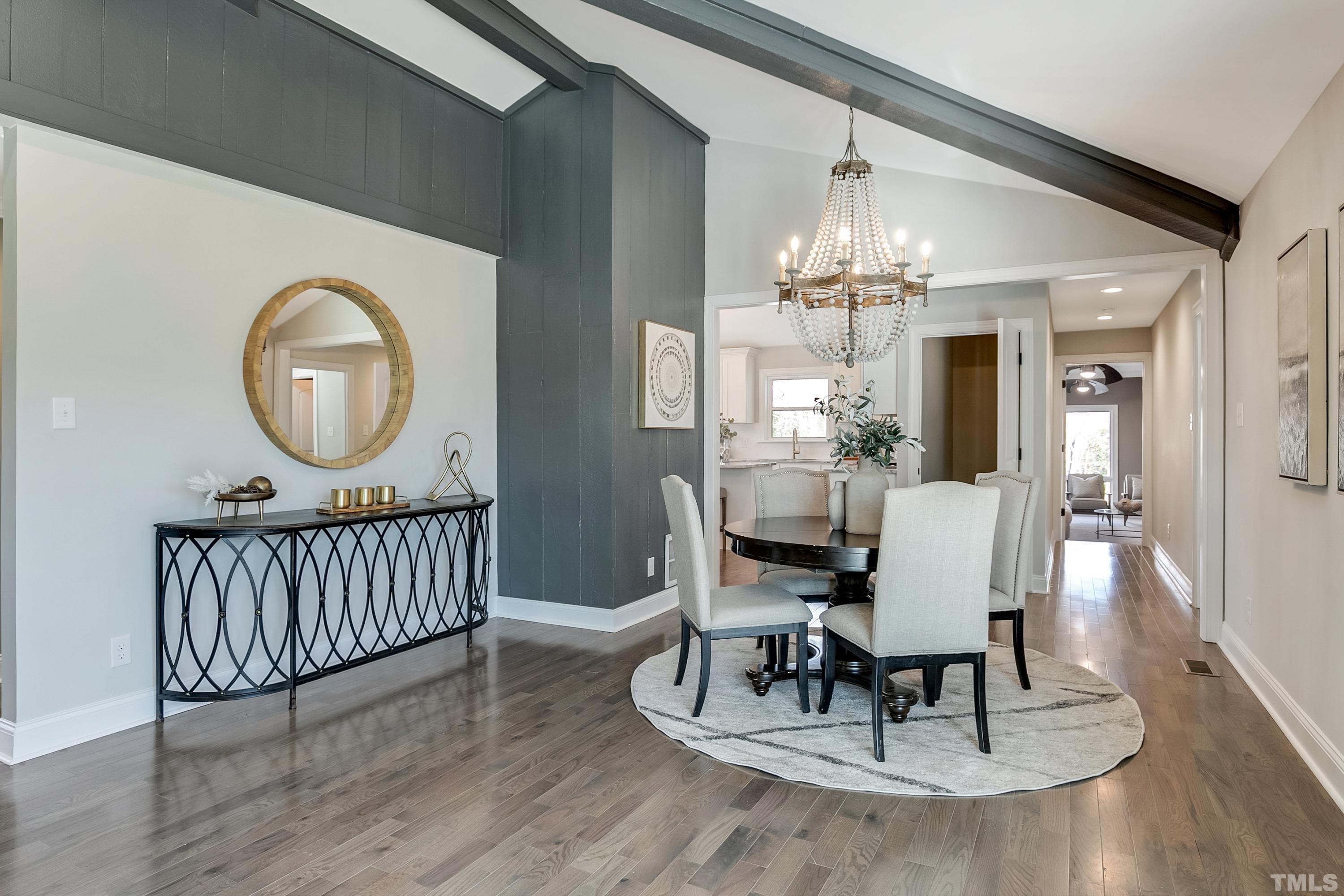 5413 Edington Lane Raleigh, NC 27604 - Photo 26 of 59 a dining room with wooden floor a chandelier a wooden table and chairs