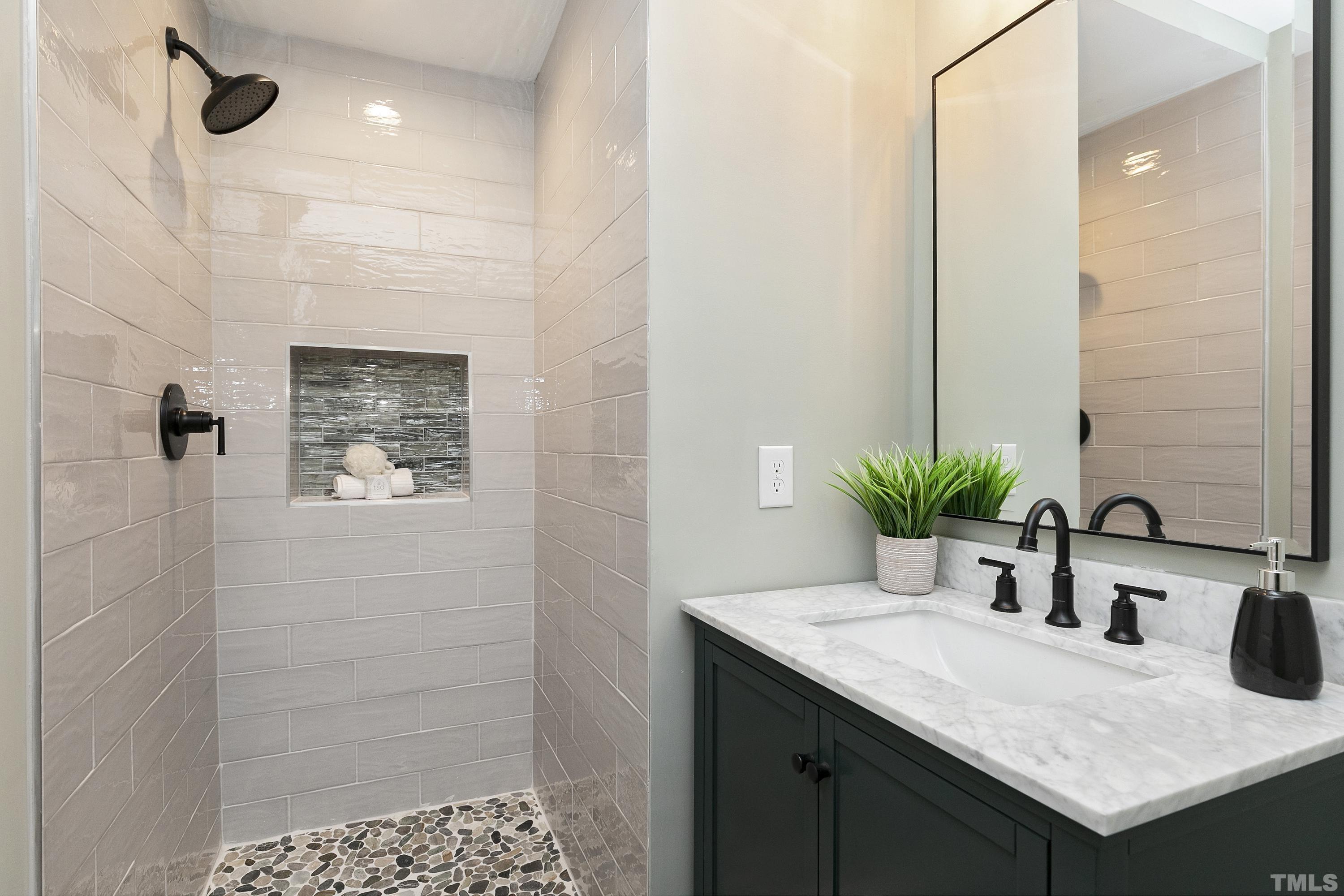 5413 Edington Lane Raleigh, NC 27604 - Photo 32 of 59 a bathroom with a granite countertop sink a mirror and shower