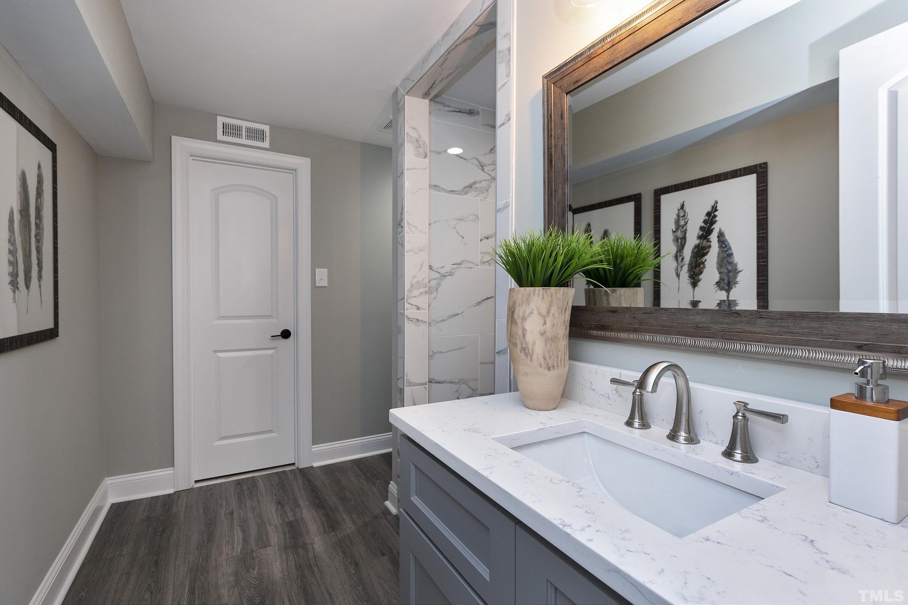 5413 Edington Lane Raleigh, NC 27604 - Photo 34 of 59 a bathroom with a sink and a mirror
