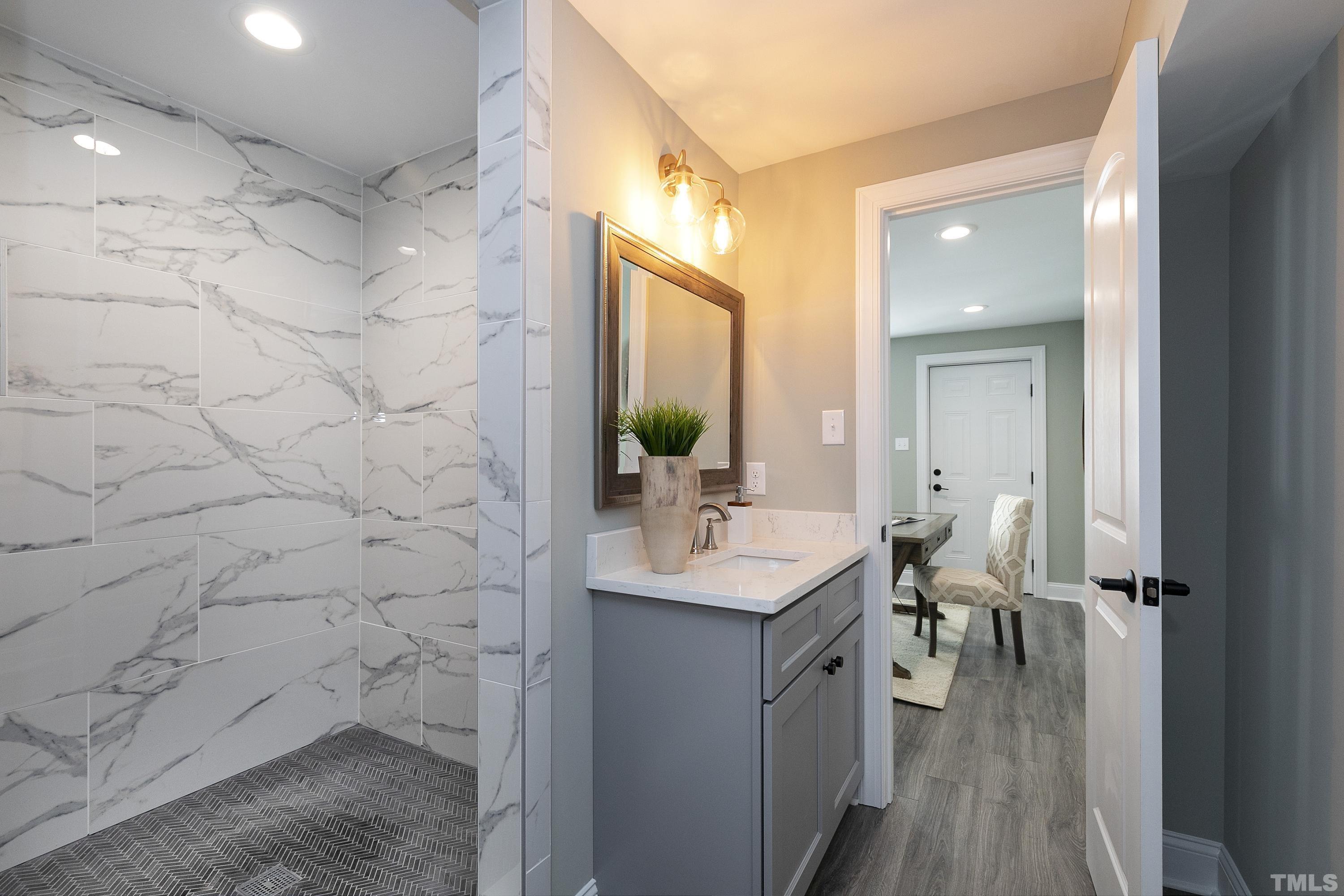 5413 Edington Lane Raleigh, NC 27604 - Photo 35 of 59 a bathroom with a sink a mirror and shower