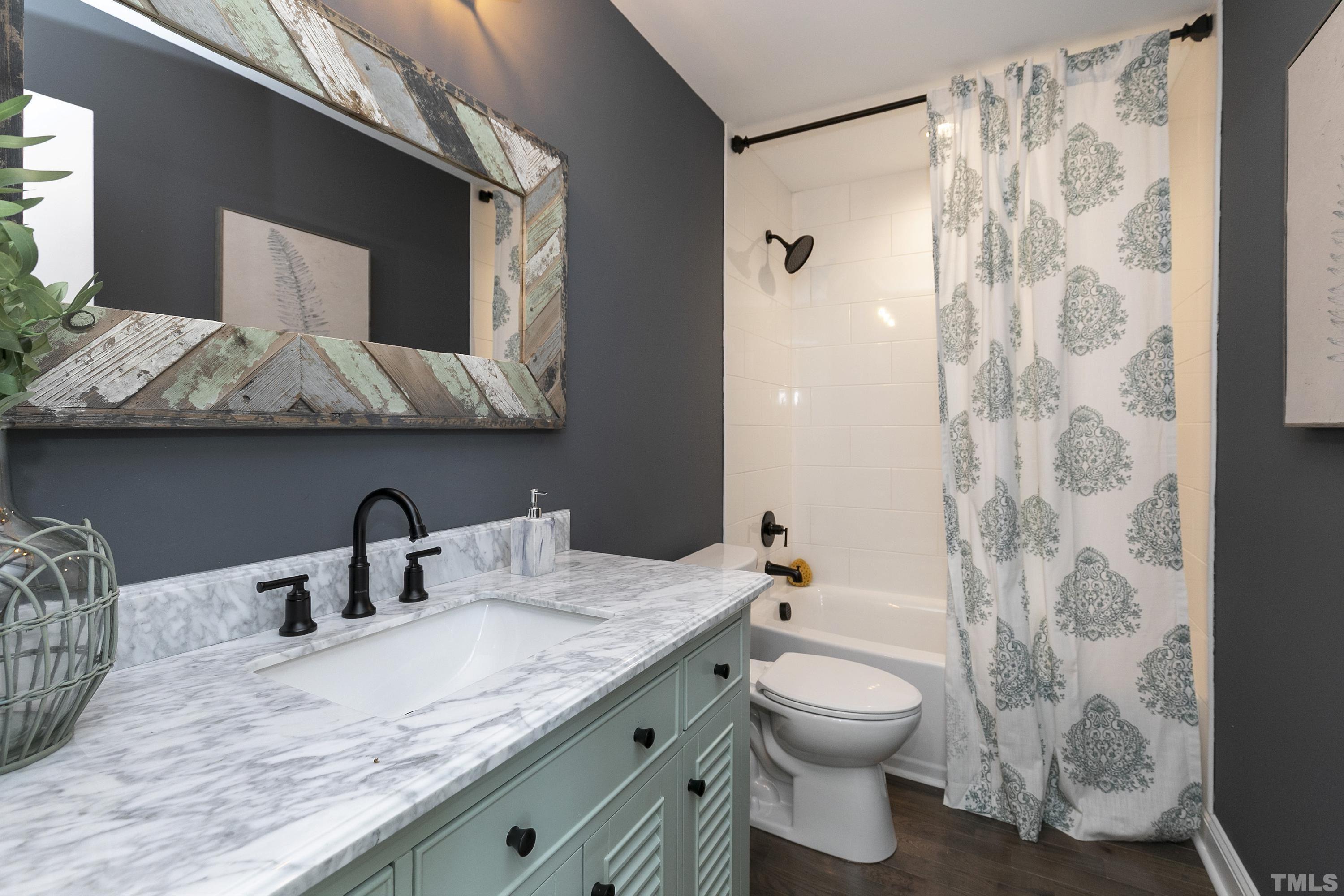5413 Edington Lane Raleigh, NC 27604 - Photo 37 of 59 a bathroom with a granite countertop sink a toilet and shower curtain