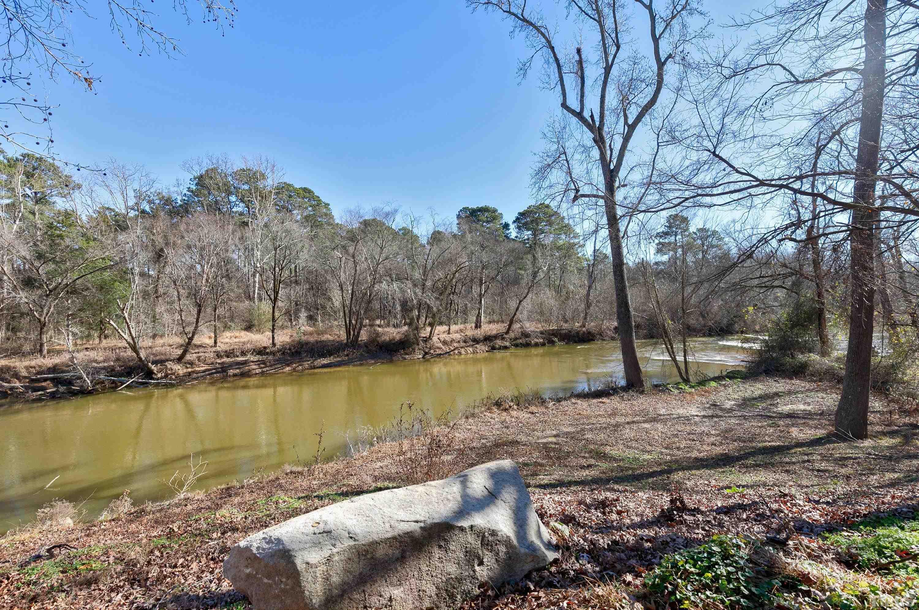 5413 Edington Lane Raleigh, NC 27604 - Photo 51 of 59 a view of a lake with houses covered with trees