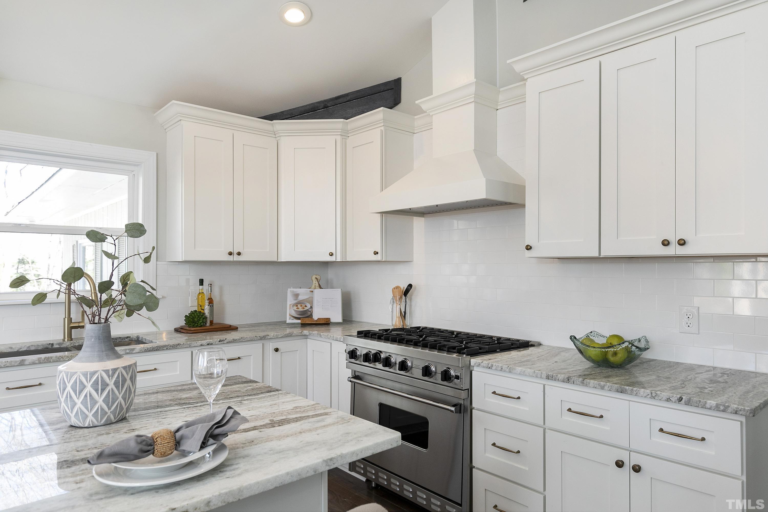 5413 Edington Lane Raleigh, NC 27604 - Photo 9 of 59 a kitchen with white cabinets and appliances