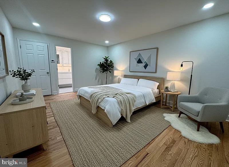 2111 Green Street, Unit 2R Philadelphia, PA 19130 - Photo 15 of 19 a bedroom with a large bed couch and a potted plant