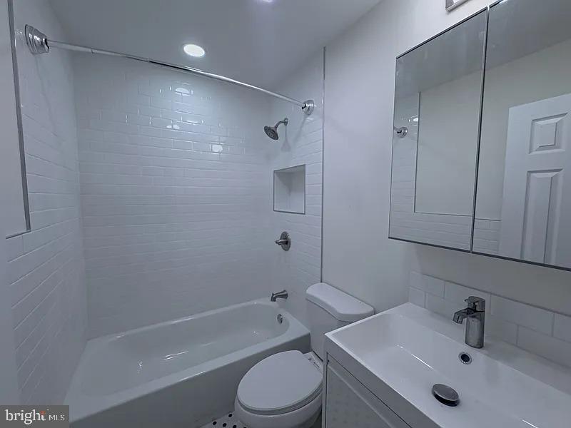 2111 Green Street, Unit 2R Philadelphia, PA 19130 - Photo 16 of 19 a bathroom with a sink toilet and shower
