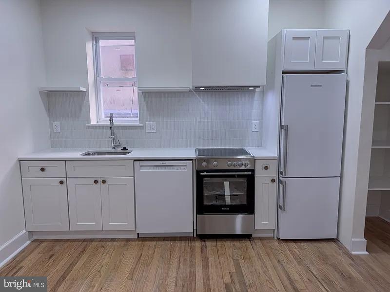 2111 Green Street, Unit 2R Philadelphia, PA 19130 - Photo 6 of 19 a kitchen with white cabinets and white appliances