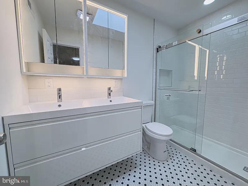 2111 Green Street, Unit 2R Philadelphia, PA 19130 - Photo 8 of 19 a bathroom with a sink a toilet and shower