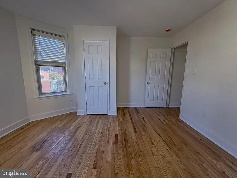 2111 Green Street, Unit 2R Philadelphia, PA 19130 - Photo 10 of 19 a view of an empty room with wooden floor and a window