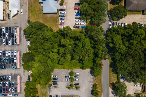 an aerial view of a house with a yard basket ball court and outdoor seating