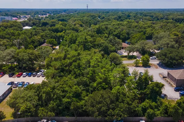 an aerial view of a houses with a yard