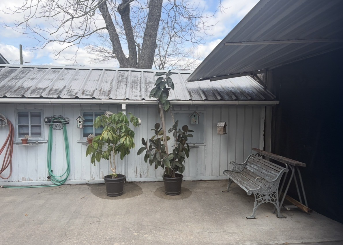 817 South Main Street Highlands, TX 77562 - Photo 4 of 17 a view of a house with potted plants and a barbeque