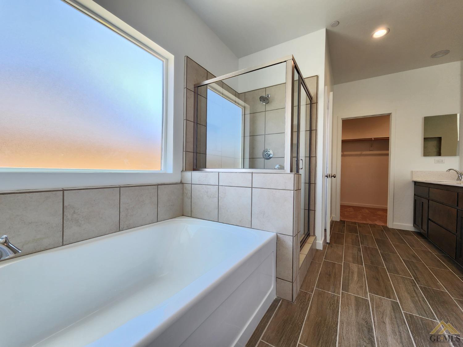 Undisclosed Address Bakersfield, CA 93313 - Photo 11 of 22 a view of a bathroom with a tub and shower