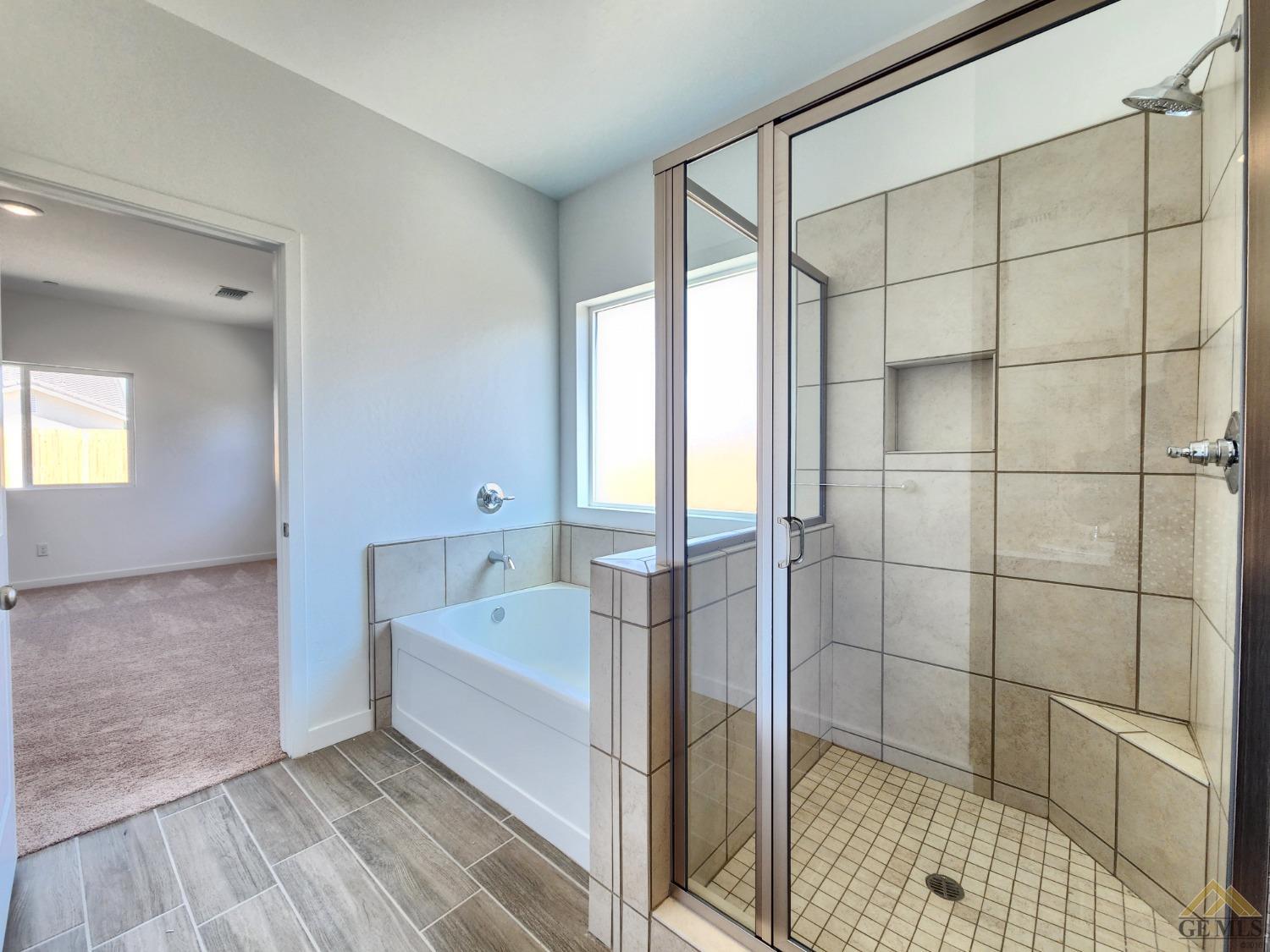 Undisclosed Address Bakersfield, CA 93313 - Photo 12 of 22 a spacious bathroom with a bathtub and a shower
