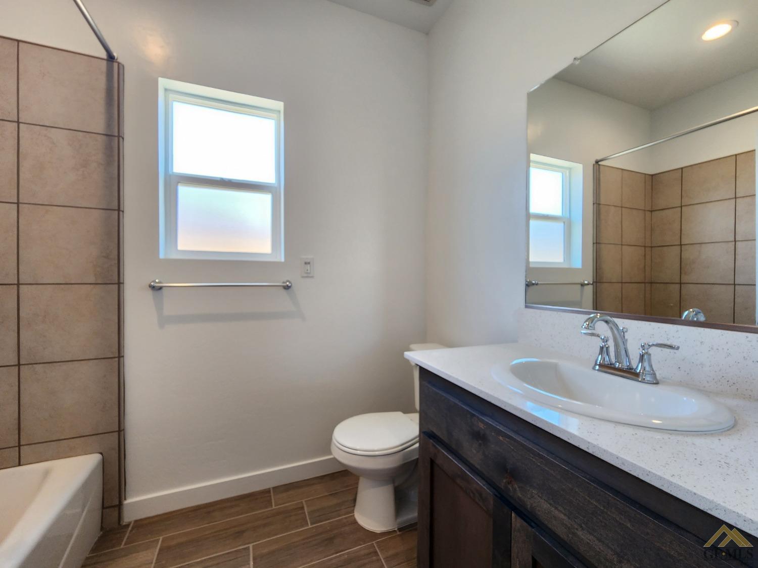 Undisclosed Address Bakersfield, CA 93313 - Photo 18 of 22 a bathroom with a sink toilet and vanity