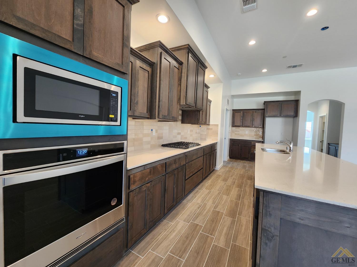 Undisclosed Address Bakersfield, CA 93313 - Photo 4 of 22 a large kitchen with stainless steel appliances wooden cabinets and stove