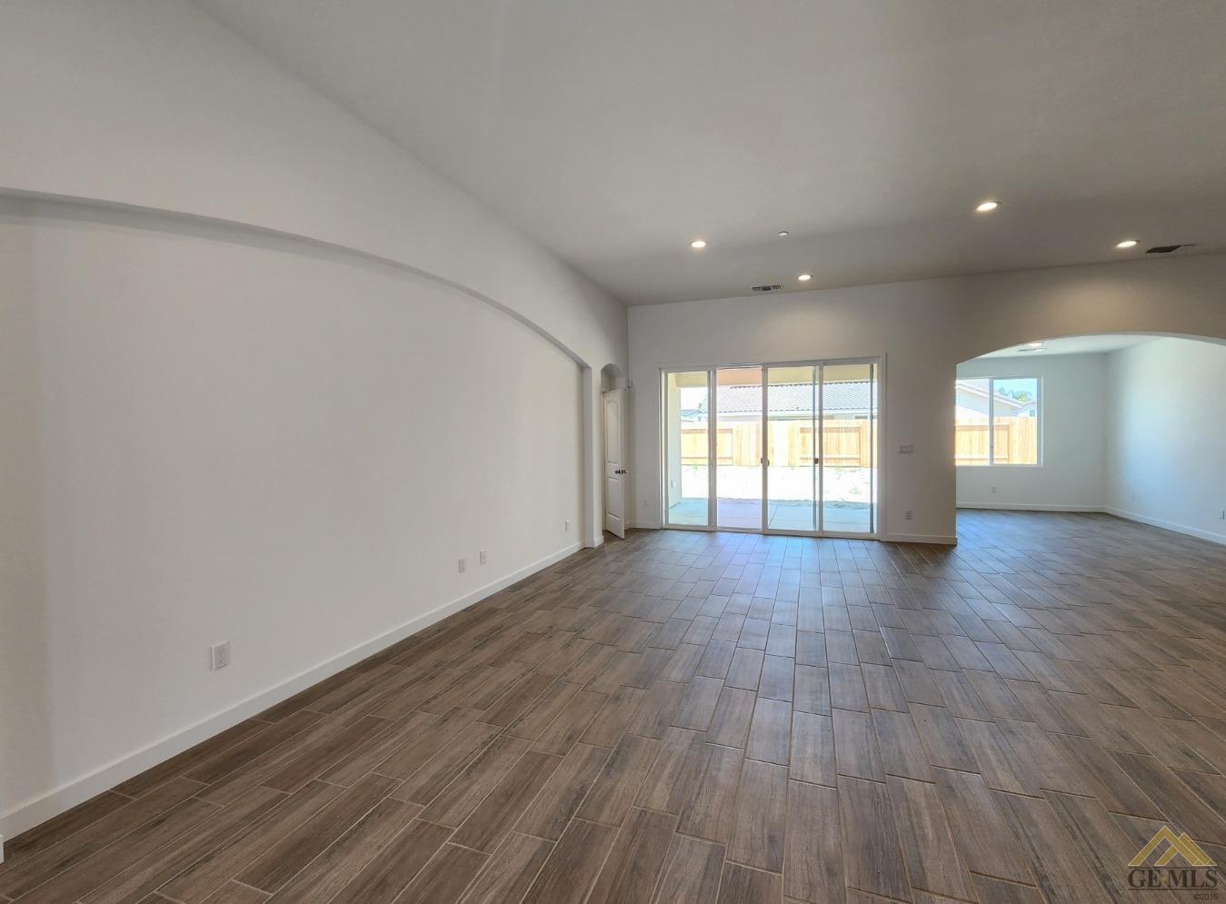 Undisclosed Address Bakersfield, CA 93313 - Photo 8 of 22 an empty room with wooden floor and windows