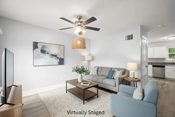 a living room with furniture and a flat screen tv