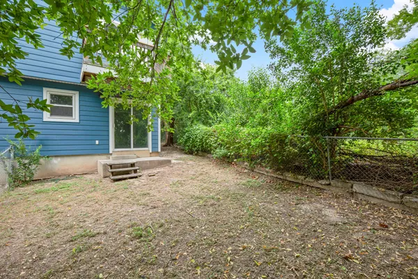 a view of a backyard with a garden and outdoor seating
