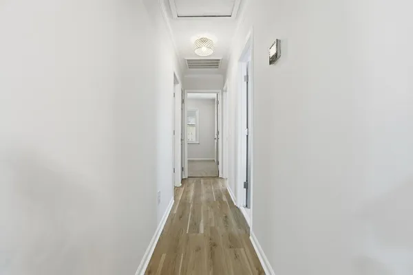 an empty room with windows and ceiling fan