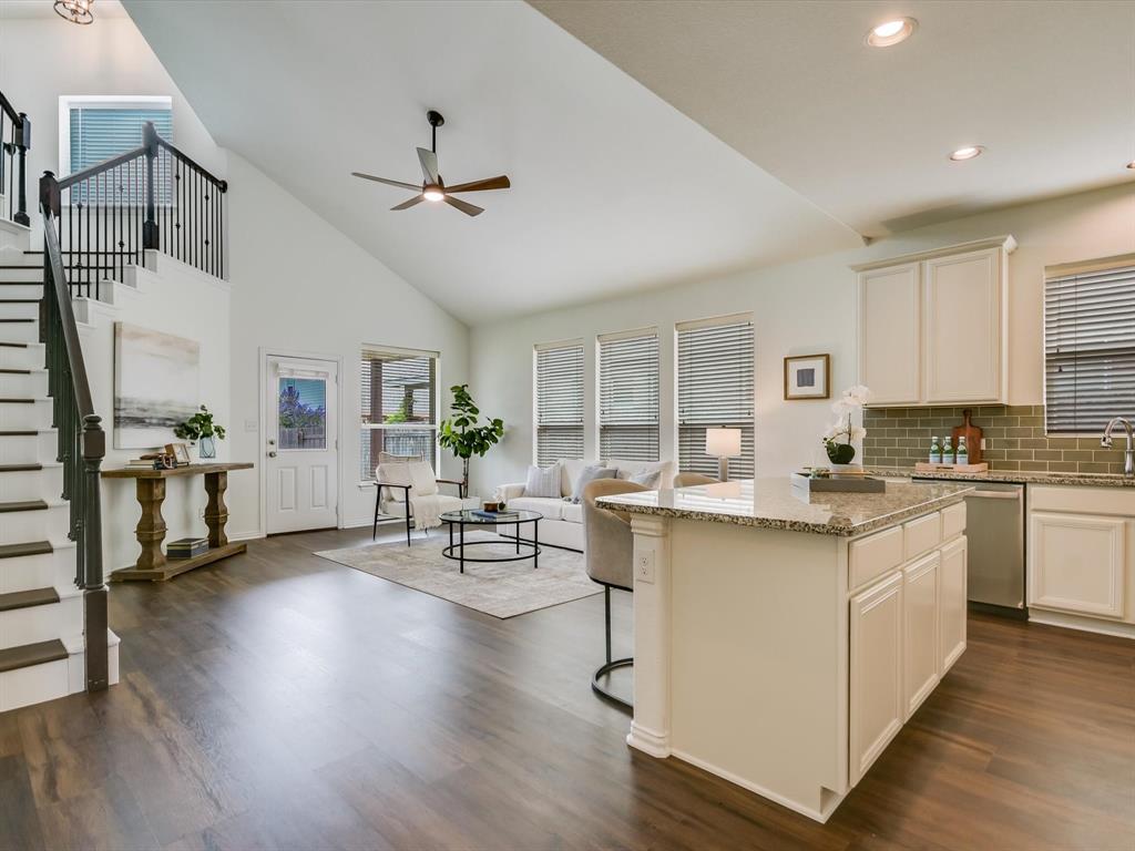 736 Bonnet Boulevard Georgetown, TX 78628 - Photo 12 of 27 a open kitchen with stainless steel appliances granite countertop a stove top oven a refrigerator a dining table and chairs with wooden floor