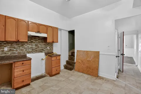 a kitchen with cabinets appliances and a window