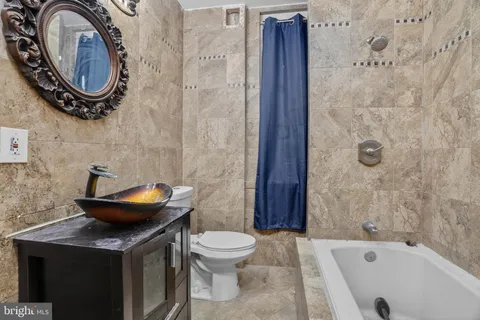 a bathroom with a sink a toilet and a tub
