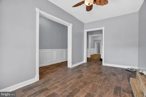 an empty room with closet and a chandelier fan