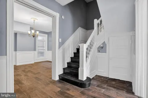 a view of entryway and hall with wooden floor