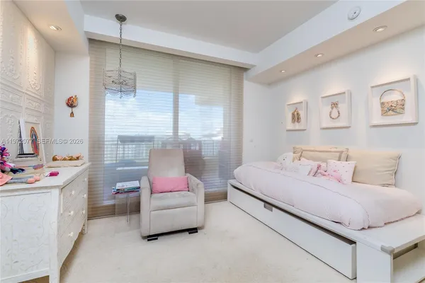 a bedroom with a bed wooden floor and window