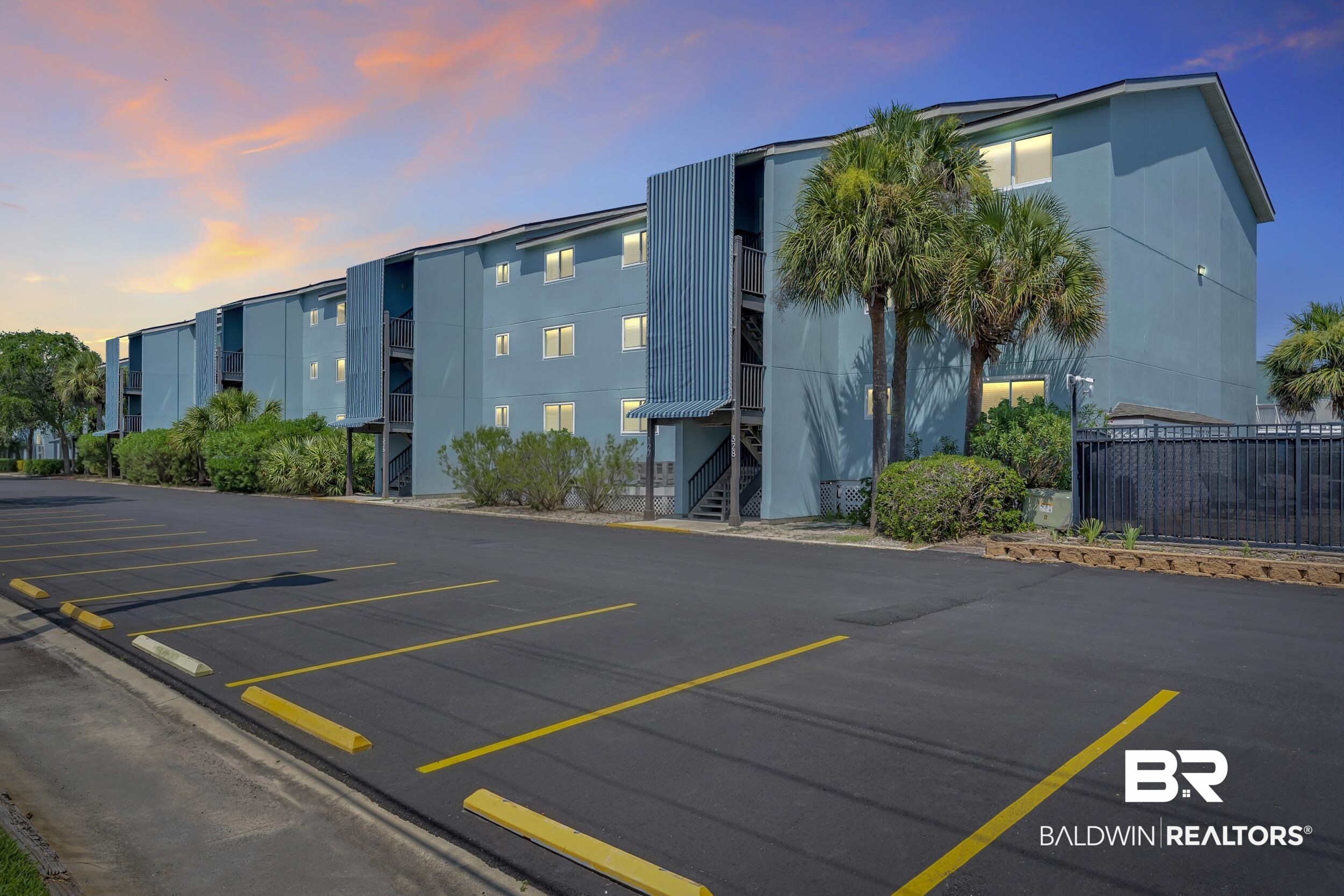 14100 River Road, Unit 211 Pensacola, FL 32507 - Photo 5 of 56 Multi-story residential building featuring blue siding, multiple windows, and exterior stairwells