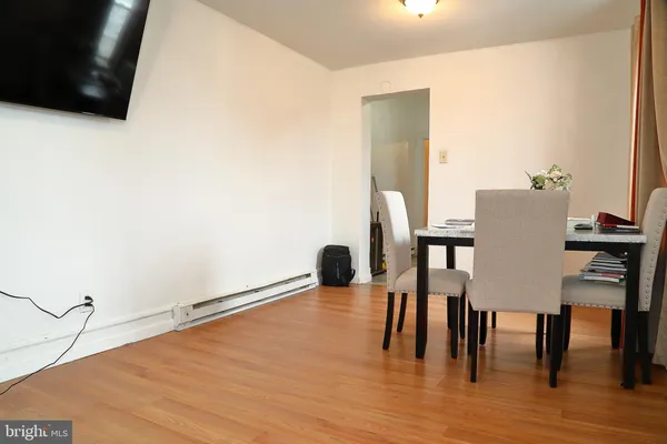 a dining room with furniture and wooden floor