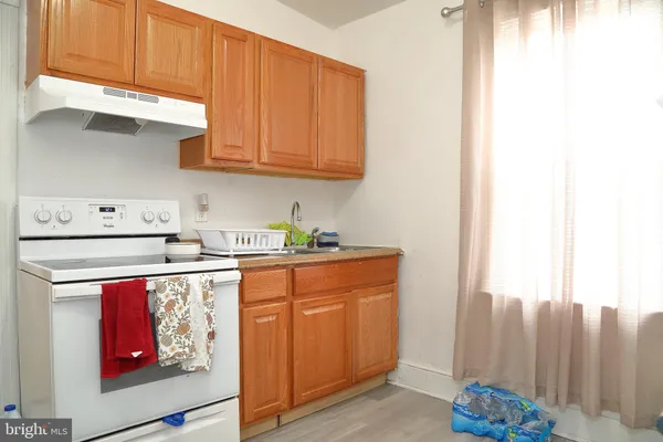 a kitchen with stainless steel appliances granite countertop a refrigerator and a stove