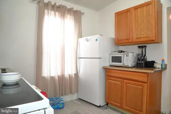 a kitchen with stainless steel appliances a refrigerator sink and cabinets