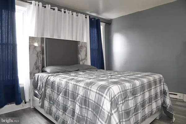 a bedroom with a bed and a flat tv screen