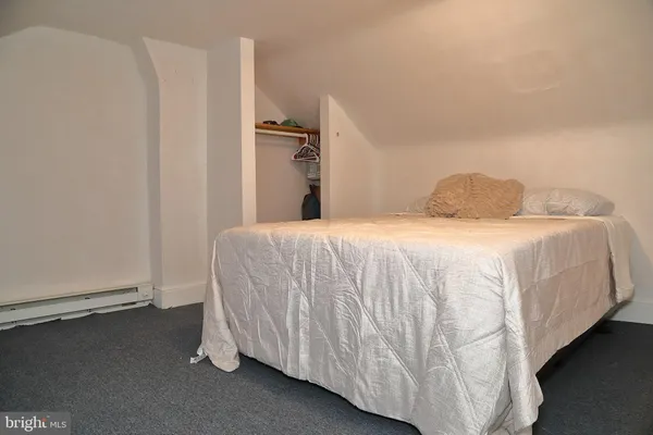 a bedroom with a bed and a night stand