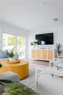a living room with a couch and potted plant