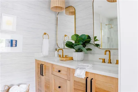 a bathroom with a granite countertop sink a toilet and shower