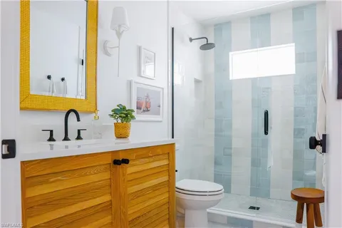 a bathroom with a granite countertop sink and a bathtub