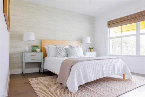 a bedroom with a bed and a lamp on table