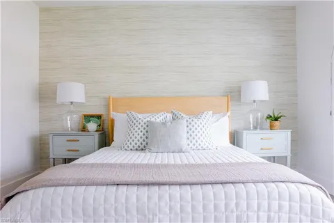 a bedroom with a bed and lamps