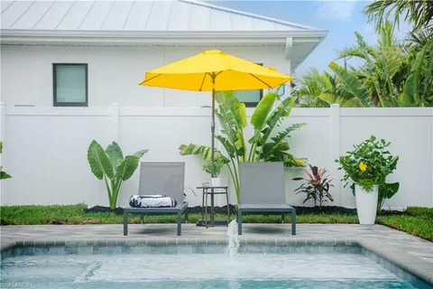 a view of a house with backyard porch and sitting area