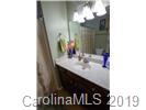 148 Roanoke Road Fletcher, NC 28732 - Photo 18 of 33 a bathroom with a sink and a mirror