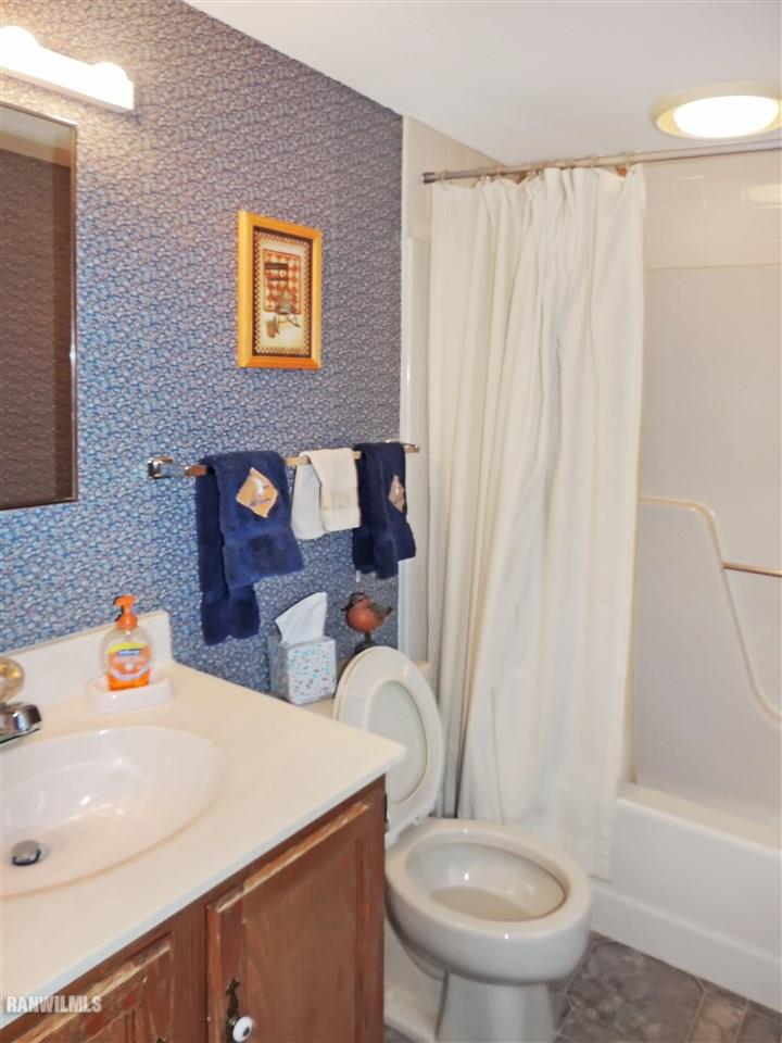 21 Thatcher Lane Galena, IL 61036 - Photo 13 of 25 a bathroom with a sink a toilet and shower curtain