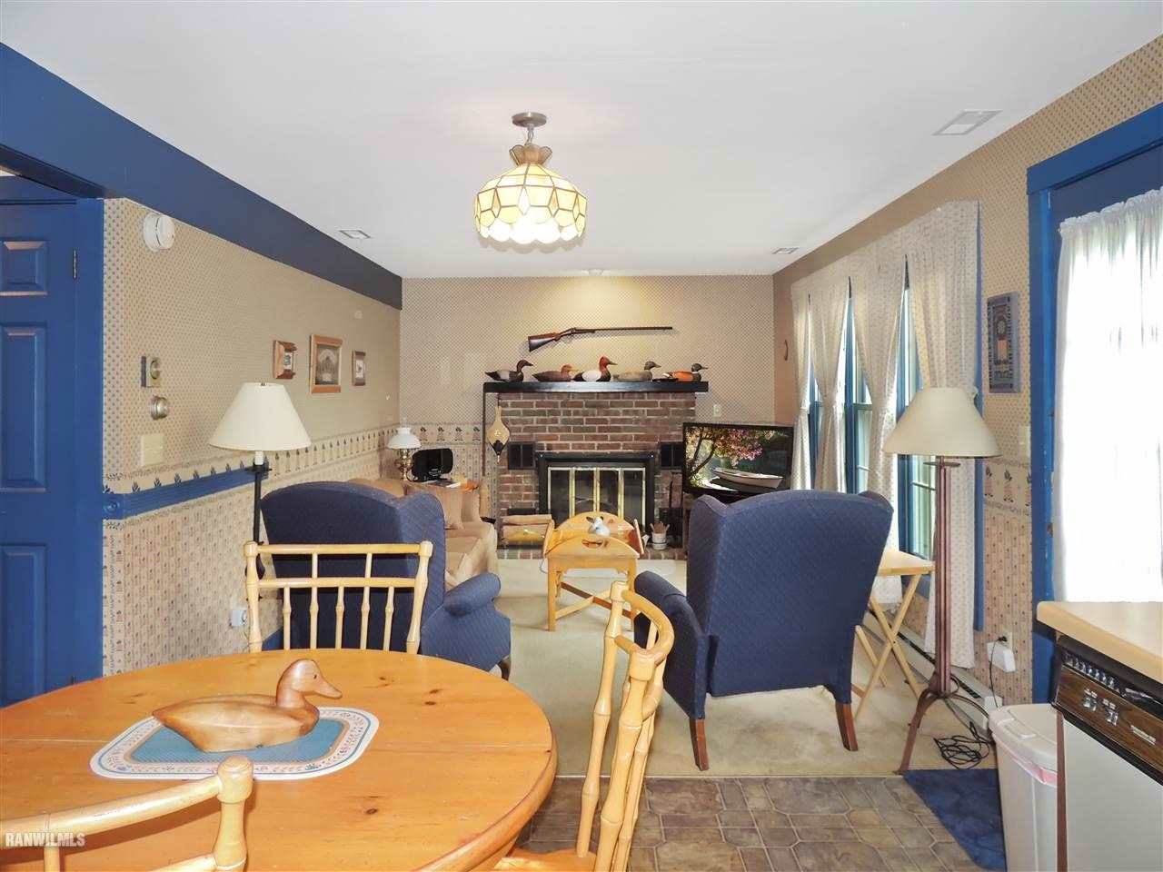 21 Thatcher Lane Galena, IL 61036 - Photo 7 of 25 a view of a dining room with furniture a chandelier and wooden floor