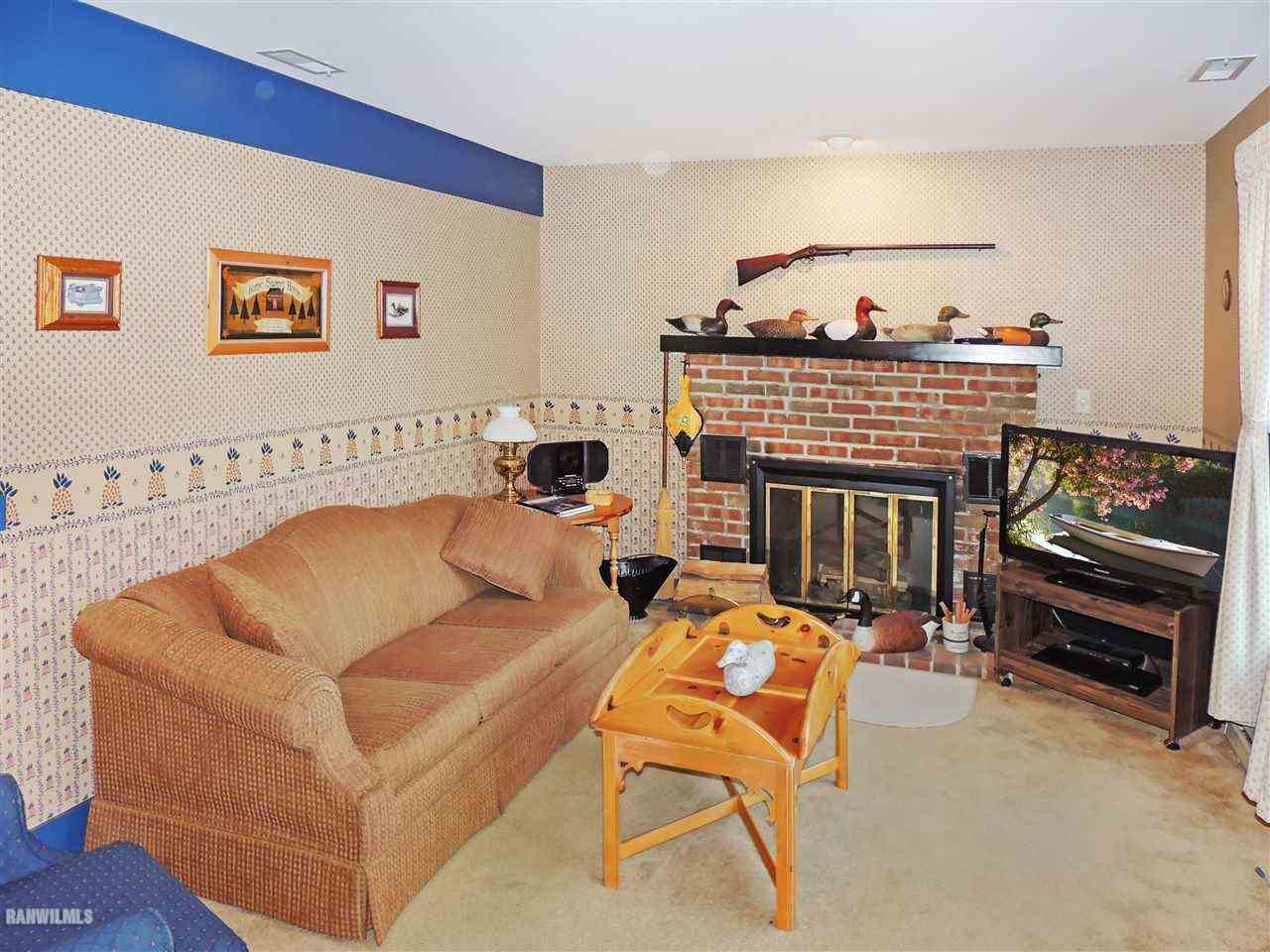 21 Thatcher Lane Galena, IL 61036 - Photo 8 of 25 a living room with furniture a flat screen tv and a fireplace